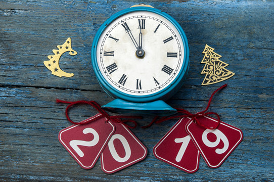 2019 new year and alarm clock on blue wood table with copy space, top view