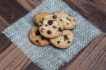  delicious cookie with chocolate drops, over wooden table and rustic tin.