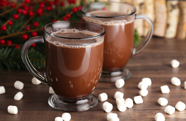 Pair of Mugs Filled with Hot Chocolate and Marshmallows on a Wooden Table