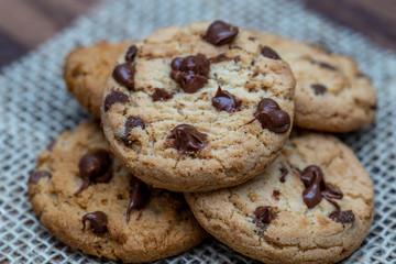  delicious cookie with chocolate drops, over wooden table and rustic tin.
