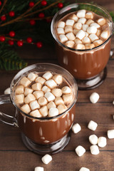 Pair of Mugs Filled with Hot Chocolate and Marshmallows on a Wooden Table