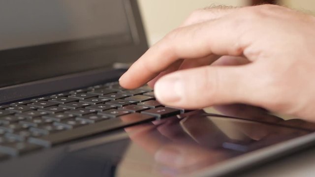 Male hand typing on keyboard
