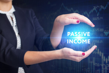 The concept of business, technology, the Internet and the network. A young entrepreneur working on a virtual screen of the future and sees the inscription: Passive income