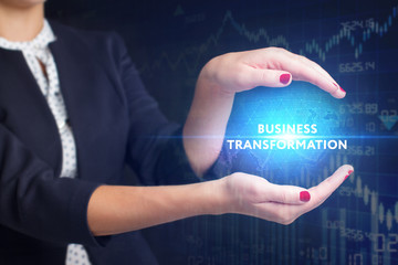 The concept of business, technology, the Internet and the network. A young entrepreneur working on a virtual screen of the future and sees the inscription: Business transformation