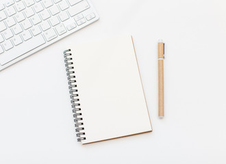 Blank notebook, pen and keyboard on white background