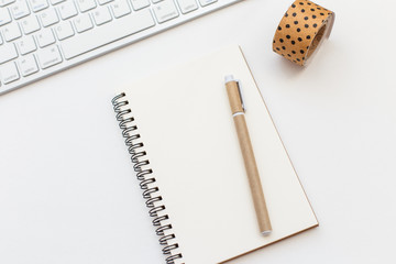 Blank notebook, pen and keyboard on white background