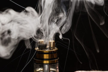 Vape close-up with smoke on a black background