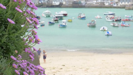 Beautiful St Ives beach being enjoyed by families in summer.
