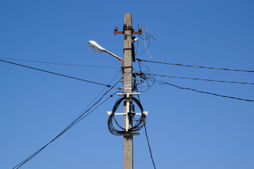 A pole with a lantern and coiled wires