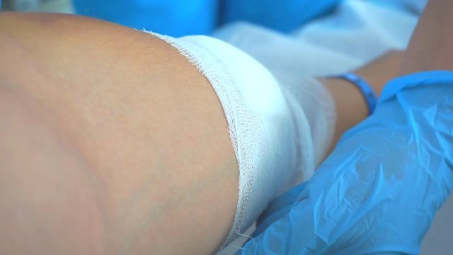 Doctor is bandaging his hand with the patient. 1920X1080 Full Hd.