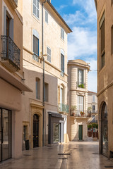     Nimes in the south of France, typical paved side street of the city center 