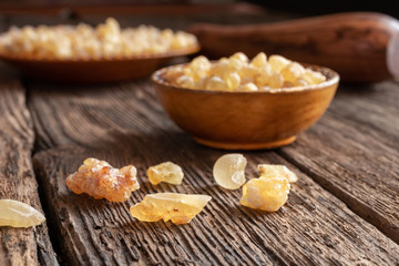 Frankincense resin crystals on a wooden background