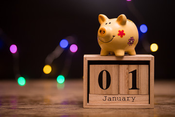 Calendar date of Financial Year start, 1st january with piggy bank on dark background