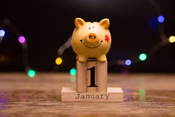 Calendar date of Financial Year start, 1st january with piggy bank on dark background