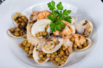 Hake in clam sauce and prawns with peas