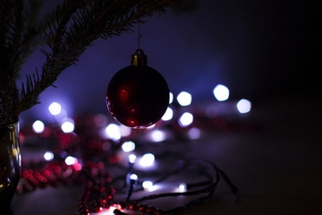 Christmas red ball. bokeh and spruce branch. New Year's holidays