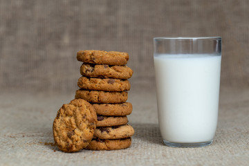  Photograph of a glass of milk with homemade cookies. American type cookie, tasty and very beautiful.