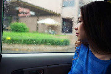 Pensive woman in car