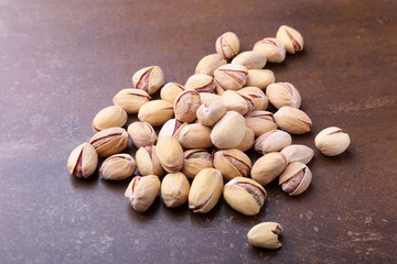 Salt pistachios on a stone table. Close-up.