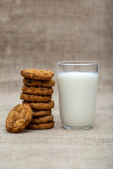  Photograph of a glass of milk with homemade cookies. American type cookie, tasty and very beautiful.