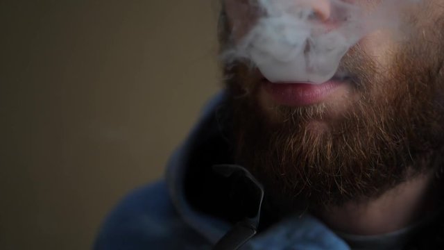 Pipe smoking young man with red beard