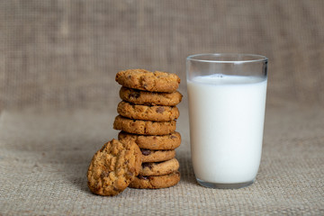  Photograph of a glass of milk with homemade cookies. American type cookie, tasty and very beautiful.