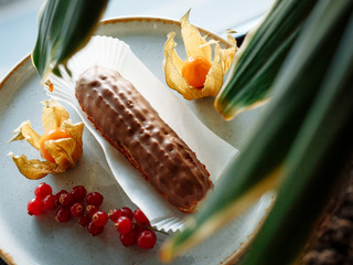 eclair cake on a plate decorated with citrus and berries