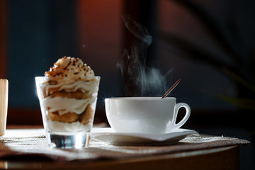 cup, saucer, spoon and dessert in a glass