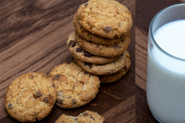  Photograph of a glass of milk with homemade cookies. American type cookie, tasty and very beautiful.