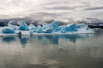 Fototapeta na wymiar Iceberg island with large blocks of ice floating in the water