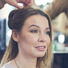 Young beautiful European girl in a beauty salon. She is preparing for an important event.