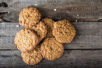 Homemade oatmeal cookies on wooden board on old table background. Healthy Food Snack Concept. Copy space. Milk and cookies. Still life of food. Christmas cookies. Healthy food. Breakfast concept.