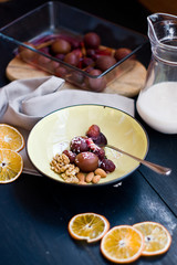 Dessert plums and walnuts on wooden background