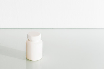White medical container on light gray background