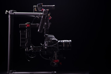 Sistem stabilization video camera and lens on steady equipment support such as gimbal steady or stabilized. Black background