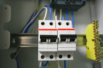 Voltage switchboard 220 volt, electrical cables with  modern circuit breakers are  in the ON...