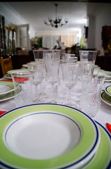 Photograph of a table prepared with dinnerware for a party like Christmas. Celebration.