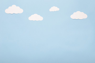 White paper clouds on a blue background. Application, the sky.