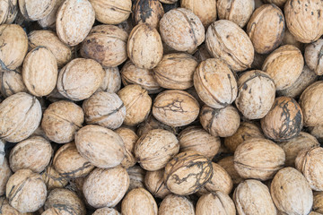 Walnuts background. Walnuts texture. Group walnuts on wooden background. Healthy organic food concept. View above.
