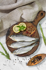 Three fish on a wooden Board. On white background. Rustic style