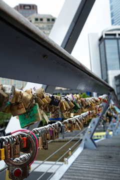 bridge full of colorful love locks with some names written on it. Most of them look old and vintage