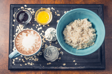 breakfast with porridge and coffee on a tray