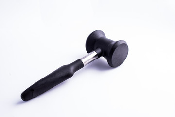 Meat mallet or tenderizer; black plastic and metal; issolated on white background