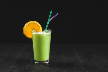 Fresh cocktail on a black background. Alcoholic cocktail on a black background. Fruit with a cocktail. Non-alcoholic cocktail. Mix of cocktails on a black background.