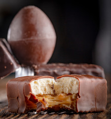 Chocolate candies on a wooden background. Close-up