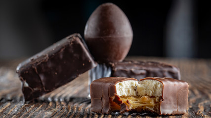 Chocolate candies on a wooden background. Close-up