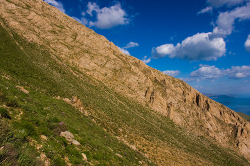 Landscape of the near mountain peak, foggy lake, cloudy sky background.