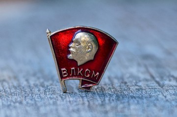 one red komsomol icon on a gray table