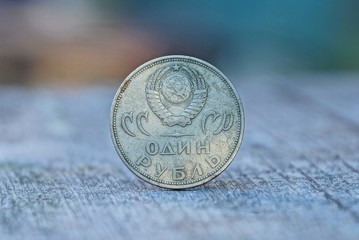 big old soviet ruble is standing on a gray table