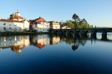 Fototapeta na wymiar Bridge and buildings reflected in river